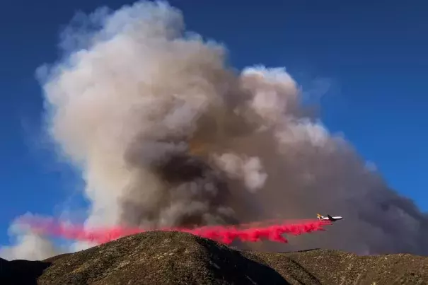 An air tanker dropped fire retardant on what has been named the Blue Cut wildfire in Lytle Creek, Calif., on Tuesday. About 700 personnel are involved in containment and evacuation efforts, officials say. Photo: Ringo Chiu, Agence France-Presse, Getty Images