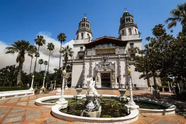 Smoke from a wildfire billows Saturday from a ridge line behind Hearst Castle in San Simeon, Calif. Photo: Joe Johnston, The Tribune, The Associated Press