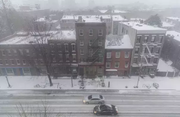 Vehicles driving through the snow on Atlantic Avenue in the Brooklyn borough of New York City on Thursday. Photo: Drew Angerer, Getty Images