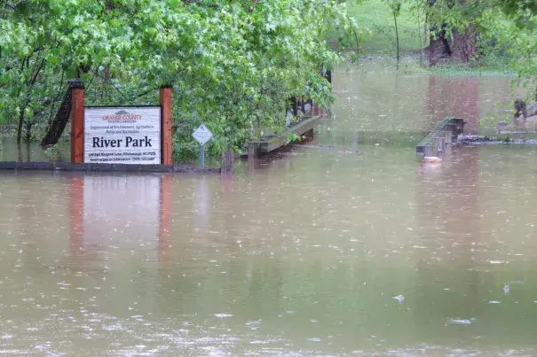 Entrance to River Park in Hillsborough. Eno River is almost above the foot bridge railings. Photo: Orange County NC Gov, @OCNGOV, Twitter
