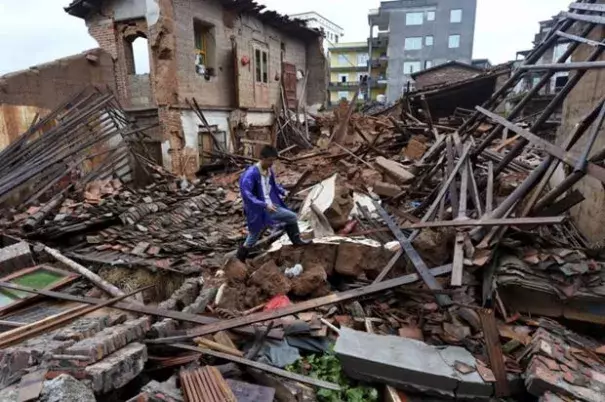 In this July 9, 2016 photo, a villager walks around a destroyed house, after torrential rainfall brought by typhoon Nepartak, in Lingcuo village of Xindu Township in Putian, southeast China's Fujian Province. Typhoon Nepartak weakened to a strong tropical storm Saturday as it lashed China's east coast, bringing powerful winds and heavy rains that toppled houses and inundated roads. Photo: Zhang Guojun/Xinhua News Agency via AP