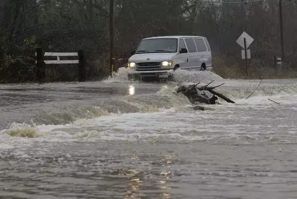 A van drives through flooded water on Green Valley Road in Graton, Calif., Saturday, Jan. 7, 2017. On the California coast, weather forecasters anticipate a storm surge from the Pacific called an atmospheric river to dump several inches of rain from Sonoma to Monterey counties, and up to a foot in isolated places in the Santa Cruz mountains. Photo: Jeff Chiu, AP