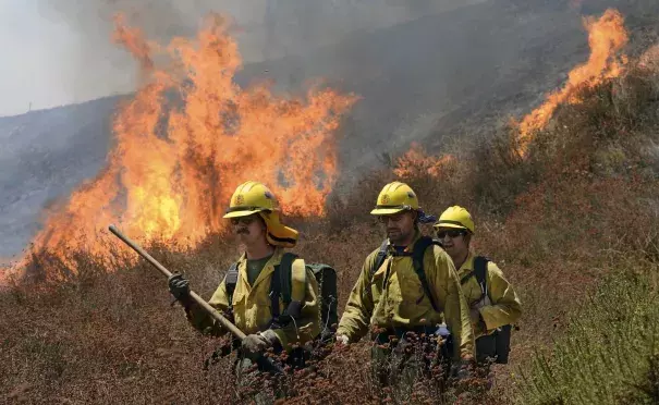 Firefighters battle the Bluecut Fire along Swarthout Canyon Road in the Cajon Pass, north of San Bernardino, Calif., Tuesday August 16, 2016. The blaze 60 miles east of Los Angeles has burned what appear to be several ranch outbuildings and forced evacuations in and around Lytle Creek. Photo: Will Lester / The Sun via Associated Press