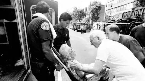 A 101-year-old woman is assisted after being overcome by heat later in the summer when an electrical fire knocked out the power in her apartment building. Photo: Chicago Tribune