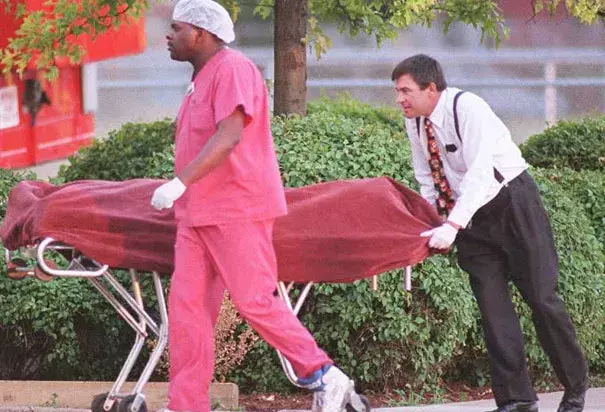 Medical examiners remove a body during the heat wave. Photo: Slate