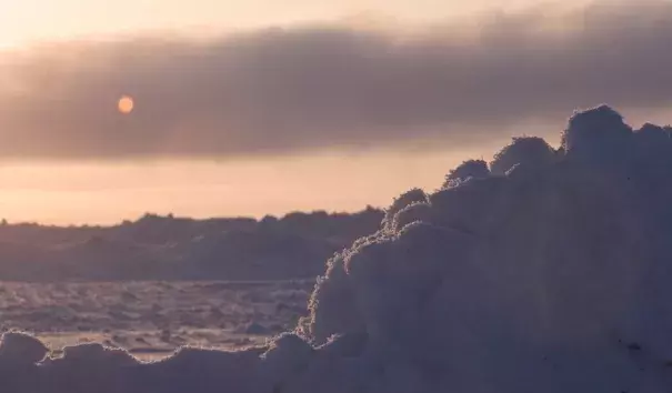 An early-spring sunset over the icy Chukchi Sea near Barrow (Utqiaġvik), Alaska, documented during the OASIS field project (Ocean_Atmosphere_Sea Ice_Snowpack) on March 22, 2009. Photo: Carlye Calvin, UCAR