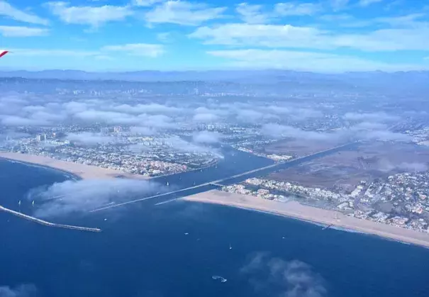 Low-level clouds over Los Angeles (seen here in early afternoon) and other urban areas of coastal southern California are becoming rarer, leading to increased fire risk. Photo: Park Williams