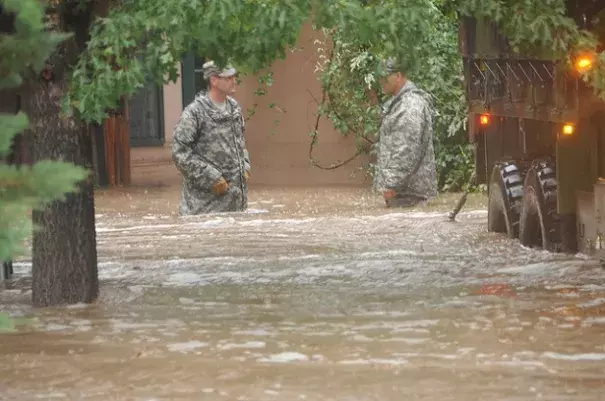 Two Colorado National Guardsmen waist deep in Boulder floodwaters. Photo: Colorado National Guard/Flickr