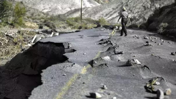 A 100-yard-long section of newly paved Highway 267 in Grapevine Canyon, a two-lane road designed to withstand severe flooding, was lifted up by roiling water and then slammed down on boulders in Death Valley National Park. (Brian van der Brug / Los Angeles Times)