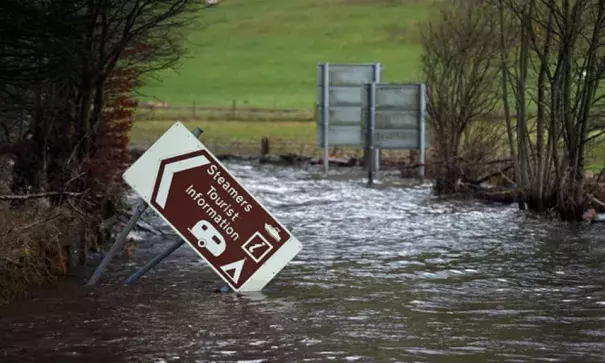 Flood water surrounds a damaged road sign as it covers a road at the northern end of Ullswater, near Pooley Bridge. Photo: Paul Ellis/AFP/Getty Images
