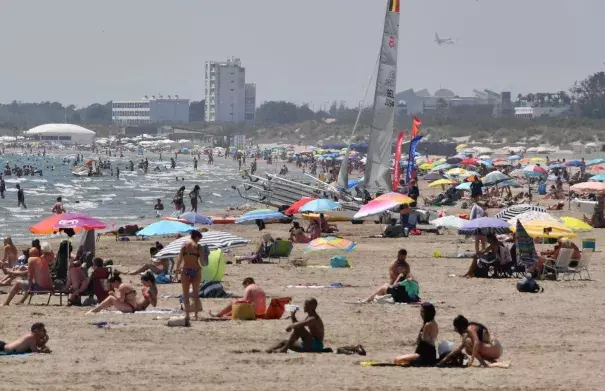 People sit on a beach in La Grande Motte, southern France, on June 28. Credit: Pascal Guyot, AFP