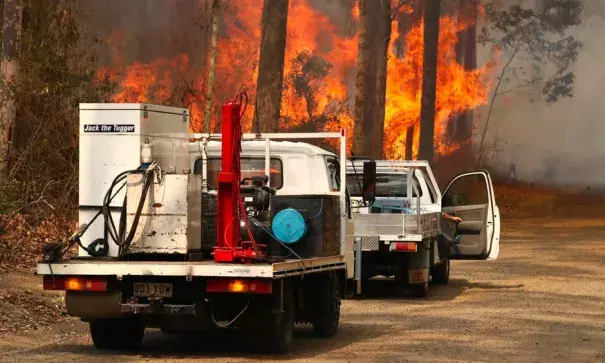 Firefighters battle bushfires in Busbys Flat, northern New South Wales, on 9 October. Photo: Jason O’Brien, AAP