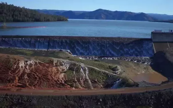 The Department of Water Resources released a video shot by a drone over the Oroville Dam. Water is seen running over the emergency spillway as well as the main spillway. Photo: Department of Water Resources