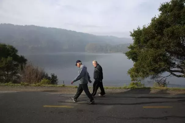 People walk along a path next to Crystal Springs Reservoir, which is starting to show a slow return to normal. Photo: Photo: Lea Suzuki, The Chronicle