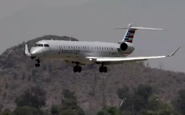 An American Eagle jet is seen through heat ripples as it lands at Sky Harbor International Airport, Monday, June 19, 2017 ,in Phoenix. American Airlines cancelled dozens flights out of Phoenix today due to extreme heat. The cancellations are for operations by smaller regional jets that have lower maximum operating temperatures than full size jets. The smaller jets can’t operate when it’s 118 degrees or higher. Photo: Matt York, Associated Press