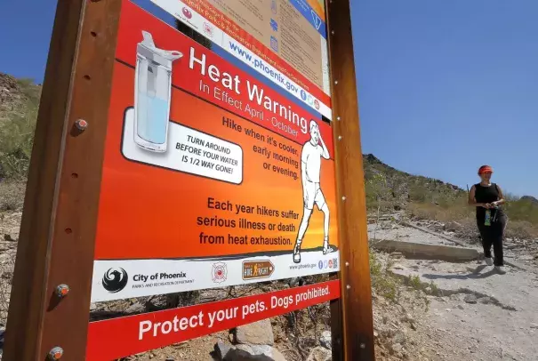 In this June 22, 2016 file photo, a sign warning of extreme heat is seen on a trailhead at Piestewa Peak in Phoenix. Thirty-one of the country’s top science organizations are telling Congress that global warming is real, a problem and something needs to be done about it. The science groups, which represent millions of scientists, sent the letter Tuesday, June 28, 2016, saying the severity of climate change is increasing and will get worse faster in coming decades. Photo: Matt York, AP