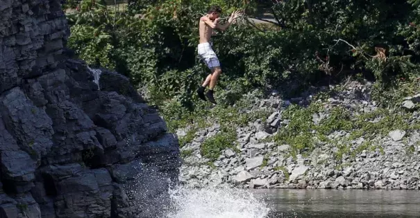A boy jumps into the Ottawa River in Quebec on August 10, 2016. Photo: Chris Wattie / Reuters
