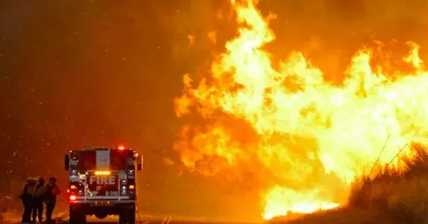 Firefighters huddle for shelter while battling a fire in Southern California this week. Photo: Reuters