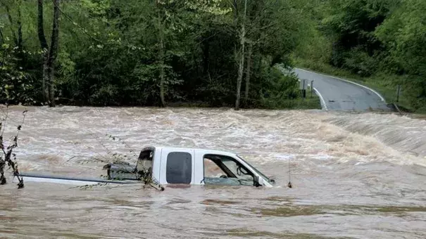 Rescuers found the driver of this truck on top of the vehicle when they arrived Monday morning in Wilkes County, North Carolina. Heavy rain is causing flooding in the Carolinas and Virginia. Photo: WXII/Bethany Moore