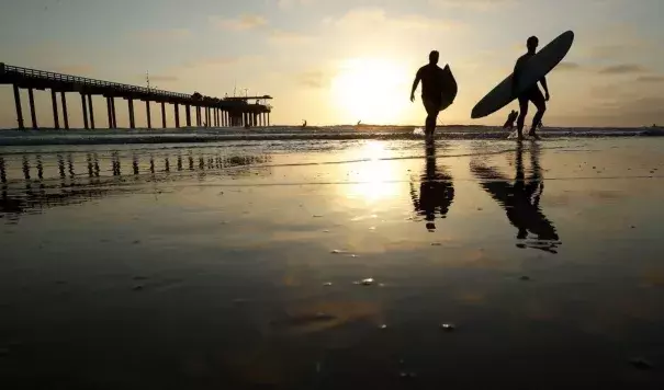 Surfers at Scripps Pier on Thursday in San Diego. Photo: Gregory Bull, AP