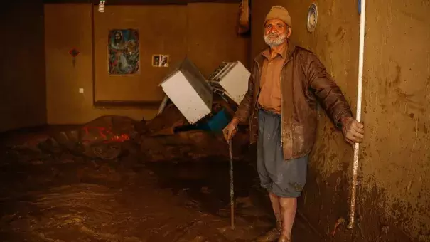 A man stands in mud in the city of Mamulan in Iran's Lorestan Province. Heavy rain and unprecedented flooding has killed at least 70 people in Iran since mid-March. Photo: Hossein Mersadi, AFP/Getty Images