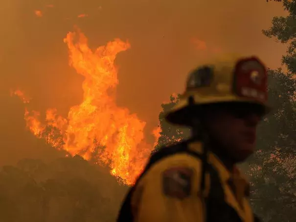 A firefighter monitors flames from the Rocky Fire as it approaches a home late last month. The wildfire has consumed thousands of acres in just over a week. Image: Justin Sullivan/Getty Images