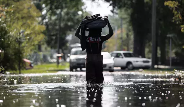 A man carries personal items through flooding associated with Hurricane Matthew on October 11, 2016, in Fair Bluff, North Carolina. Matthew, the Atlantic’s first Category 5 hurricane since 2007, left a trail of destruction from the Lesser Antilles to Virginia. Haiti was hardest hit, with more than 500 deaths and nearly $2 billion in damage. Photo: Sean Rayford, Getty Images