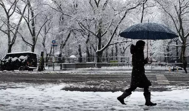 A pedestrian walks in the morning snow during an early spring storm on April 2, 2018 in New York City. The daily snowfall total of 5.5” in Central Park was the heaviest for any April day since 1982 and the seventh heaviest one-day April snow in records going back to 1869. Photo: Spencer Platt, Getty Images