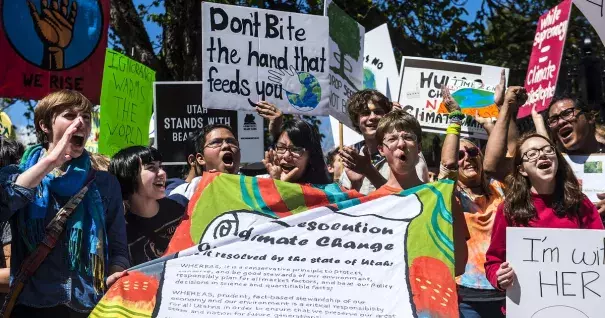 The Salt Lake Tribune Participants rally while holding their 'Student Resolution on Climate Change the Governor's Mansion during the Utah People's Climate March Saturday, April 29, 2017. Photo: Chris Detrick