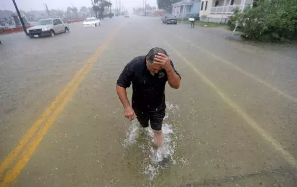 Angel Marshman wades through floodwaters from Tropical Depression Imelda after trying to start his flooded car on Sept. 18 in Galveston, Tex. Credit: David J. Phillip, AP