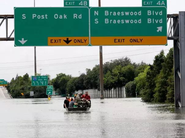 Residents are rescued from their homes surrounded by floodwaters from Tropical Storm Harvey on Sunday, Aug. 27, 2017, in Houston, Texas. Photo: David J. Phillip, AP