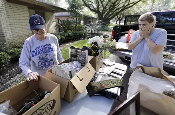 Judy Mellon, left, is helped by her daughter, Beth Kendrick, as she sorts through items damaged by floodwaters from Hurricane Harvey in Houston. Photo: David J. Phillip, AP