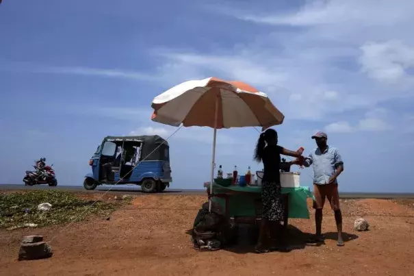 A man buys a cool drink in Sri Lanka