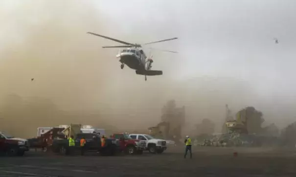 A helicopter kicks up dust as it lands at a staging area near the Oroville Dam on Monday, February 13, 2017. Photo: Rich Pedroncelli