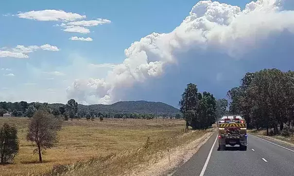 Smoke rises from the Sir Ivan fire near Coonabarabran on Sunday. Fire crews were waiting to assess damage on Monday as cooler weather brought some relief from the fire threat. Photo: Associated Press