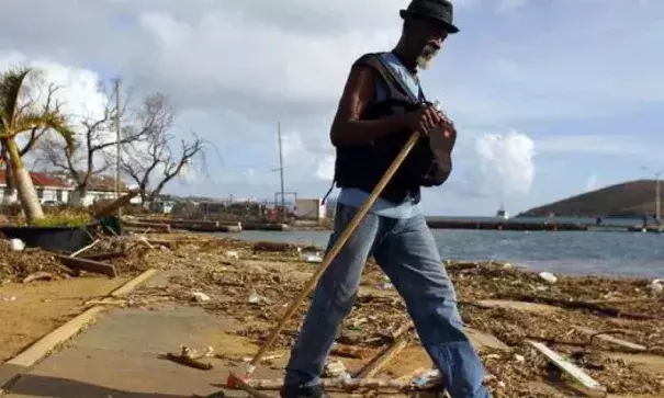 A man walks past debris caused by Hurricane Irma in Charlotte Amalie, St. Thomas, U.S. Virgin Islands, on Sept. 10, 2017. The storm ravaged such lush resort islands as St. Martin, St. Barts, St. Thomas, Barbuda and Anguilla. Photo: Ricardo Arduengo, AP