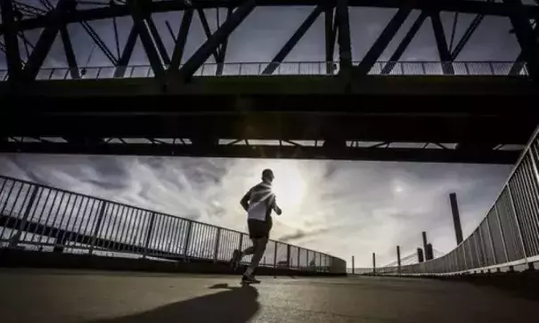 A runner makes his way up the circular path to the Big Four Pedestrian Bridge on February 14, 2017. Photo: Michael Clevenger, CJ