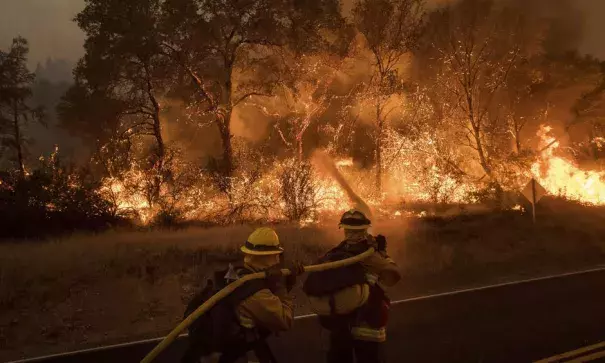 Firefighters battling a wildfire near Oroville, California, on Saturday, July 8. Photo: Noah Berger, AP