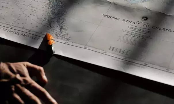 Polar maritime lawyer Scott Joblin, from the Australian National University in Cambria, looks over a map aboard the Finnish icebreaker MSV Nordica as it sets sail in the North Pacific Ocean toward the Bering Strait, Thursday, July 6, 2017. Photo: David Goldman, AP