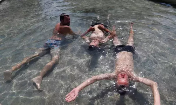 Men cool off in a fountain in Budapest, Hungary. Photo: Reuters