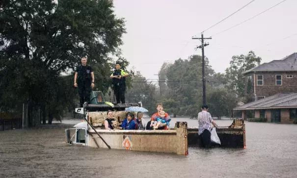 Rescue workers and civilians waited for emergency crews on Sunday in the Meyerland area of Houston. Photo: Alyssa Schukar, The New York Times