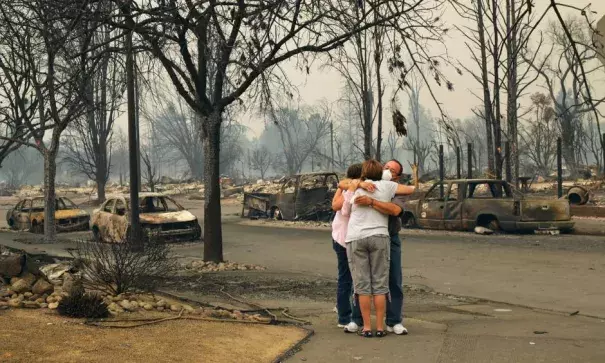 Neighbors Tina and Art Anaya hugged Lisa Coats in the streets of their neighborhood in Santa Rosa on Monday. Photo: Jim Wilson, The New York Times