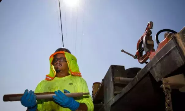 While working in 100 degree heat, Lyle Surber, a driller's assistant, carries drilling equipment in Gilroy on Sept. 1, 2017. Suber and his coworkers were taking soil samples as a part of a project to update the sewer system in Gilroy. Photo: Dai Sugano/Bay Area News Group