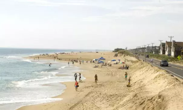 A beach nourishment project underway in Kitty Hawk, North Carolina, shows the difference between a newly nourished beach, in the background, and an area where the shoreline has eroded. Photo: Nicholas Kusnetz, InsideClimate News