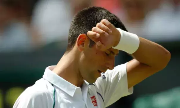 Novak Djokovic of Serbia wipes his face during the hottest day in Wimbledon history, in a match against Jarkko Nieminen of Finland, at the All England Lawn Tennis Championships in Wimbledon, London, Wednesday July 1, 2015. Photo: Alastair Grant, AP