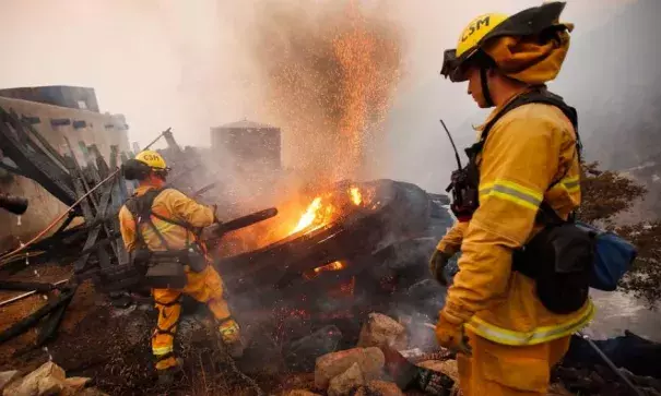 Firefighters work Dec. 12 to extinguish a burning structure that is threatening other buildings and homes high above Toro Canyon in Carpinteria. Photo: Al Seib, Los Angeles Times