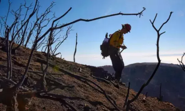 In this photo provided by the Santa Barbara County Fire Department, Santa Barbara County Fire Capt. Ryan Thomas hikes down steep terrain below East Camino Cielo to meet with his crew and root out and extinguish smoldering hot spots in Santa Barbara, Calif., Tuesday, Dec. 19, 2017. Officials estimate that the Thomas Fire will grow to become the biggest in California history before full containment, expected by Jan. 7, 2018. Photo: Mike Eliason, Santa Barbara County Fire Department via AP