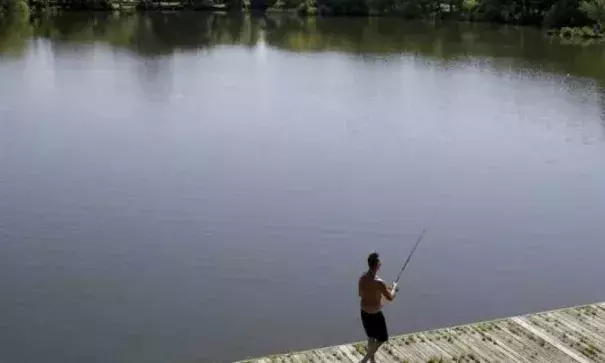 Hugh Poole fishes at a pond in FDR Park in Philadelphia, Thursday, May 24, 2018. Photo: David Maialetti, AP