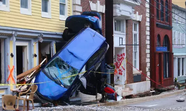 Cars overturned by flash flooding lean together on a sidewalk in Ellicott City, Maryland. Photo: Howard County government 