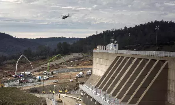 Reconstruction continued Wednesday in a race to shore up the emergency spillway, left, at the Oroville Dam. Photo: Brian van der Brug, Los Angeles Times